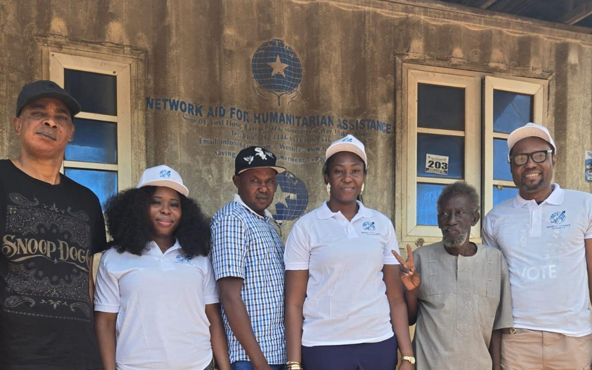World Impact Initiative team with partners outside the Network Aid for Humanitarian Assistance office